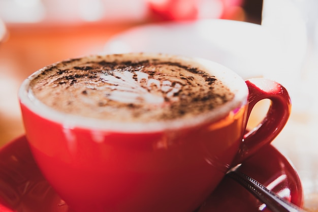 A cup of coffee on blurred background.