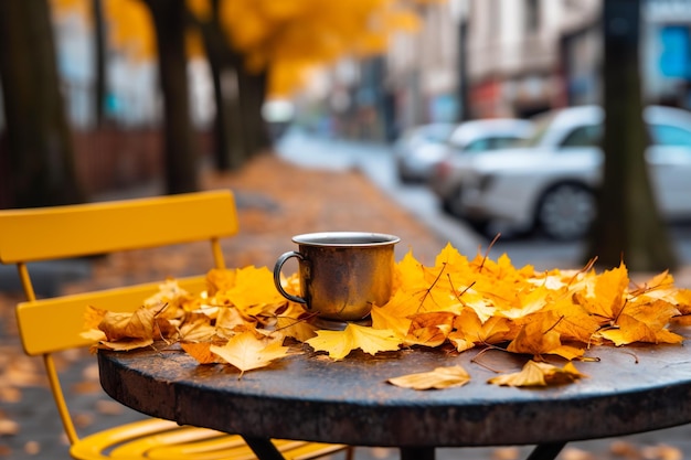 A cup of coffee on a cafe table street with autumn leaves