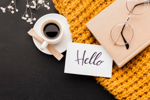 a cup of coffee and a card that says hello