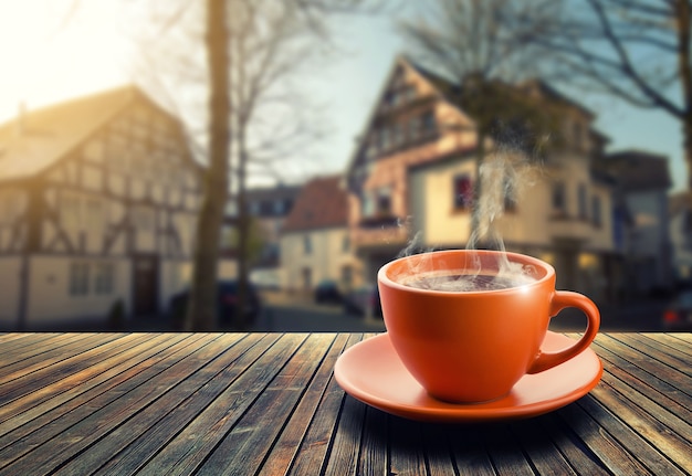 Cup of coffee on city background