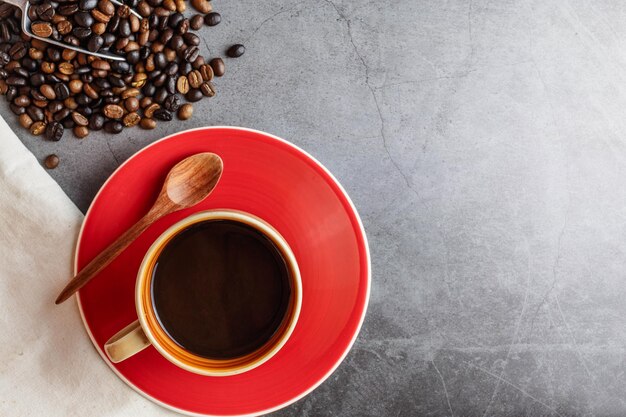 A cup of coffee  and coffee beans top view