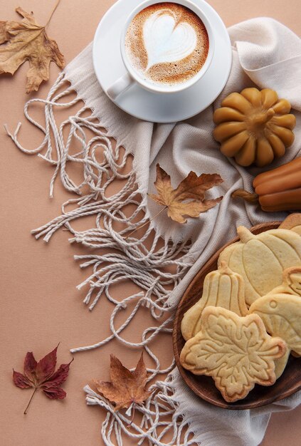 Cup of coffee cookies on tray yellow leaves