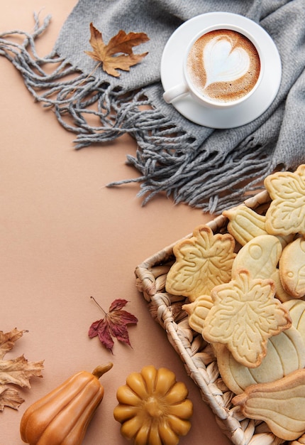 Cup of coffee cookies on tray yellow leaves