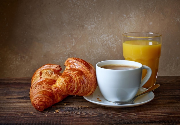 Cup of coffee croissants and orange juice