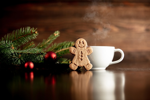 Cup of coffee and gingerbread man cookie