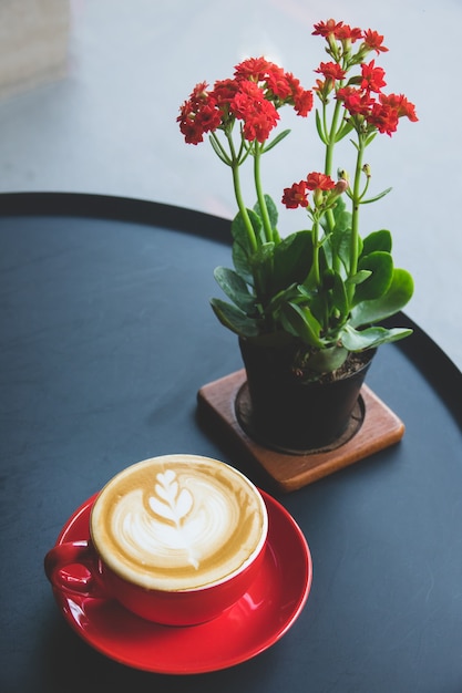 Cup of coffee latte art on the desk in coffee shop 