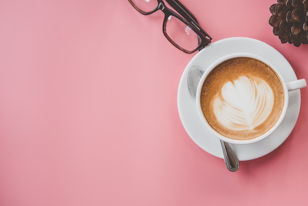 cup of Coffee latte art Heart shape with copy space on pink table