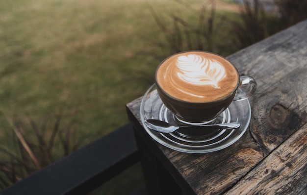 Cup of coffee latte on wood bar