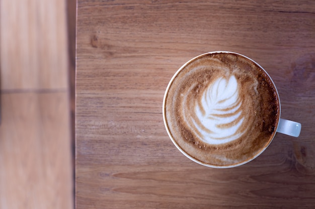 Cup of coffee latte on wood table.