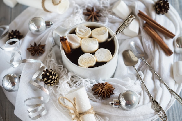 A cup of coffee and marshmallow in the New Year Christmas table setting