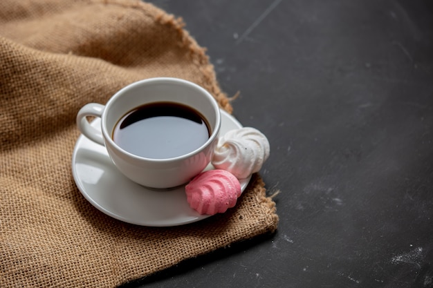 Cup of coffee and Meringue on a table