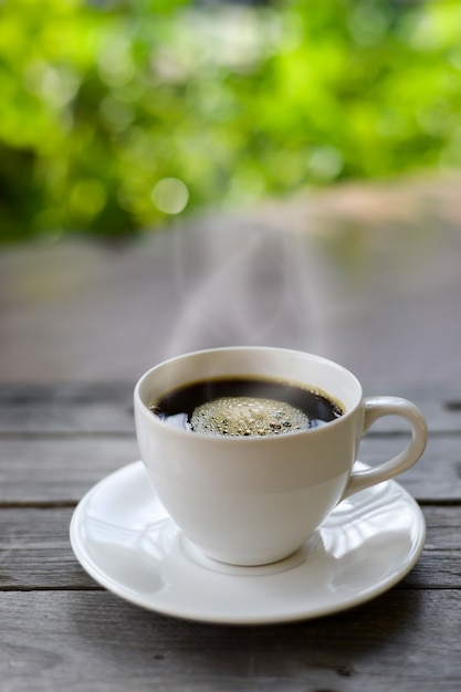 Cup of coffee on nature background.