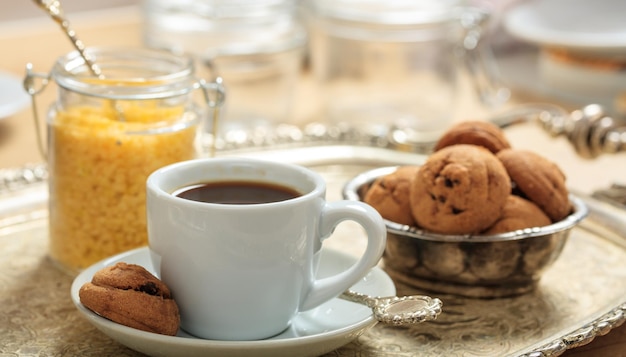 A cup of coffee on an old tray