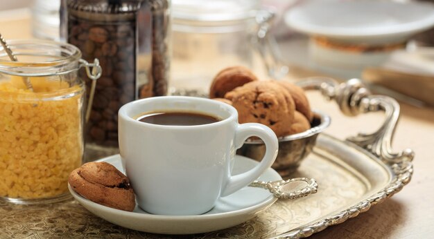 A cup of coffee on an old tray