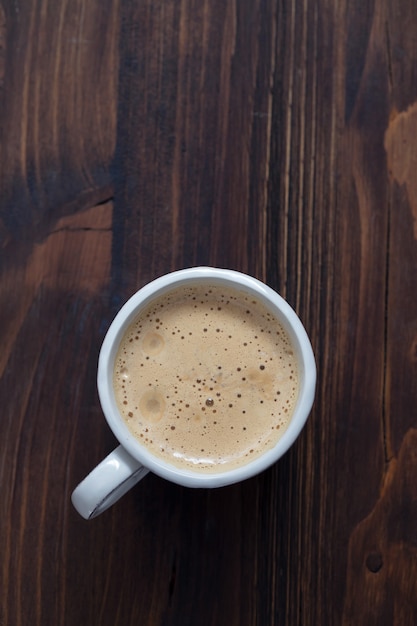 A cup of coffee on old wooden surface