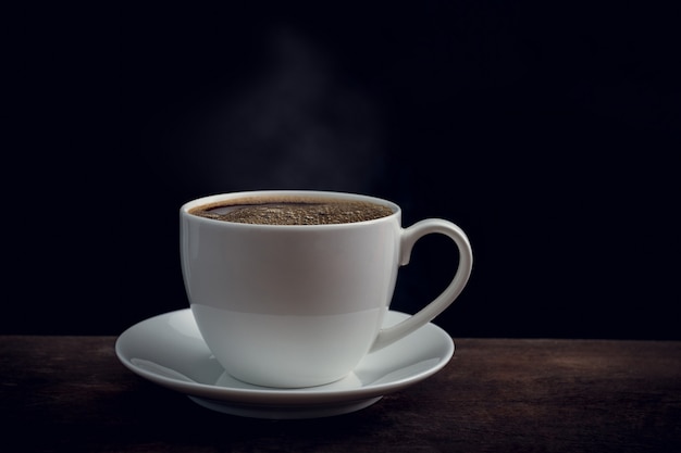 Cup of coffee on old wooden table