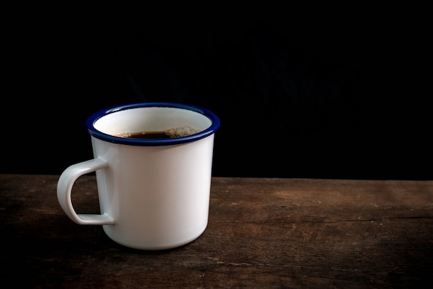 Cup of coffee on old wooden table