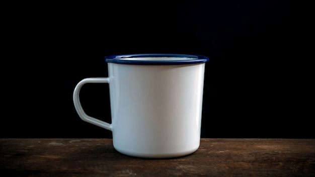 Cup of coffee on old wooden table