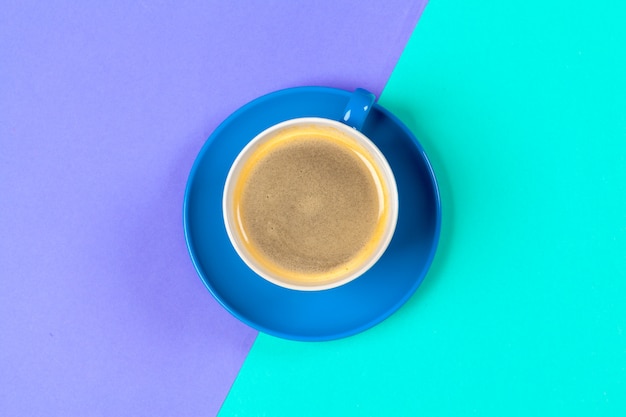 Cup of coffee and saucer on color