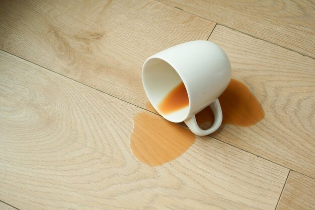 Cup of coffee spilled on floor