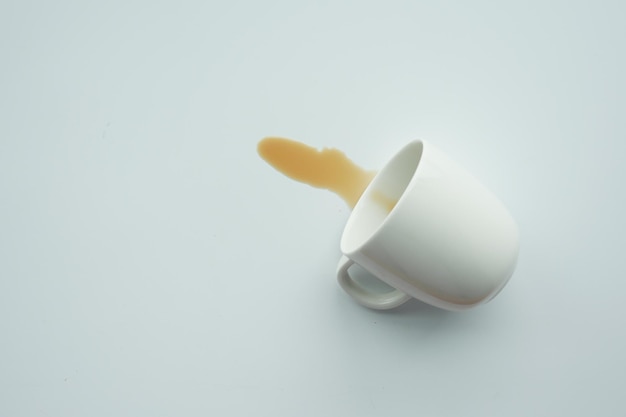 Cup of coffee spilled on white