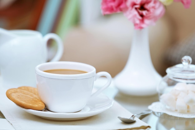 Cup of coffee on table in living room