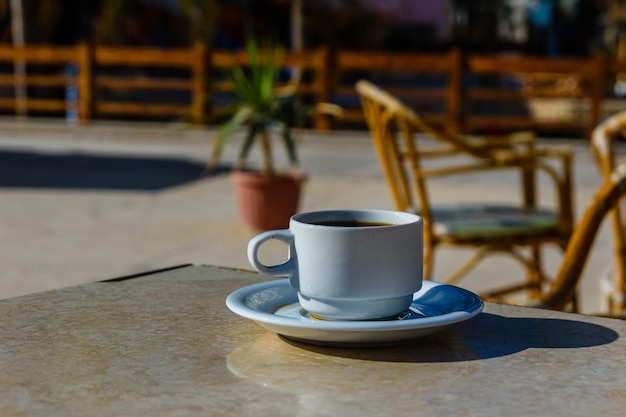 Cup of coffee on a table in street cafe