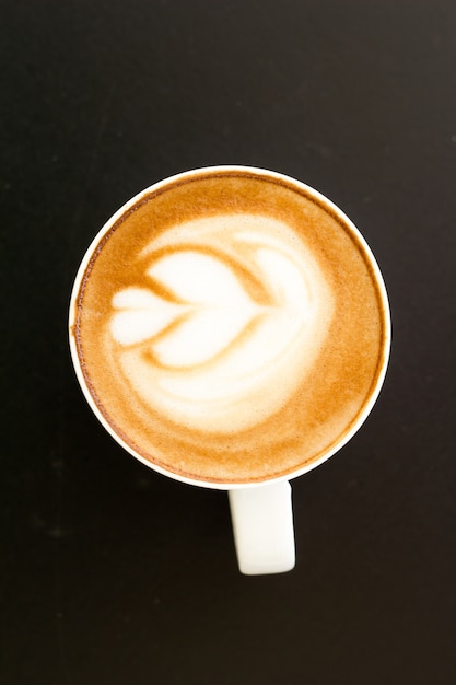 cup of coffee on table, view from above