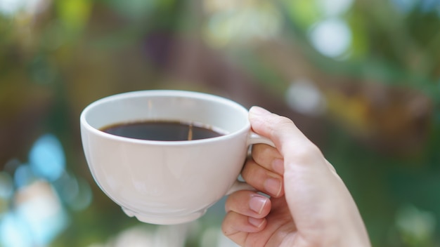 Cup of coffee or tea in woman hand