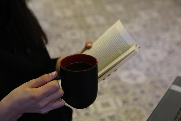 A cup of coffee while reading a book or magazine