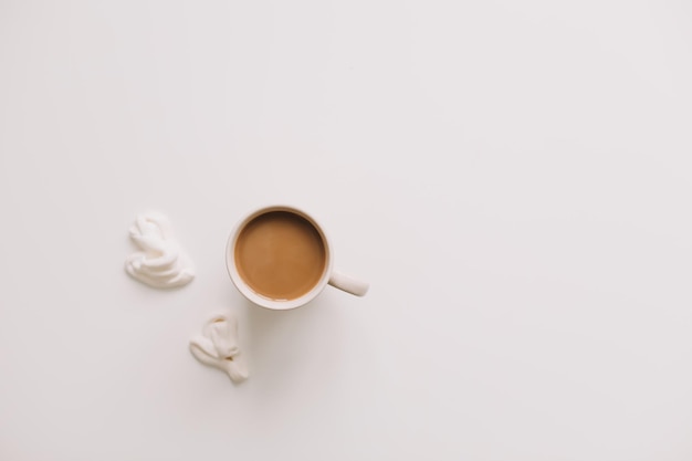 Cup of coffee on a white table top view flat lay