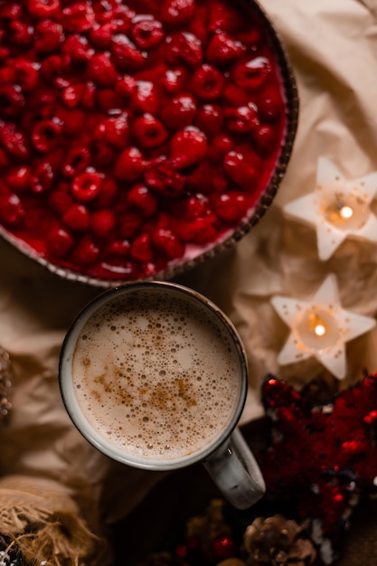 A cup of coffee with a bowl of coffee and a bowl of coffee with a red berries on it