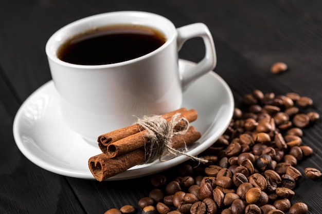 Cup of coffee with brown sugar on a wooden table.