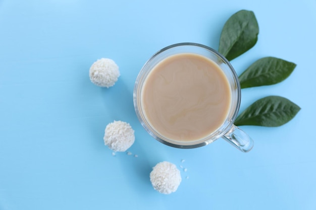 A cup of coffee with candy on a blue background