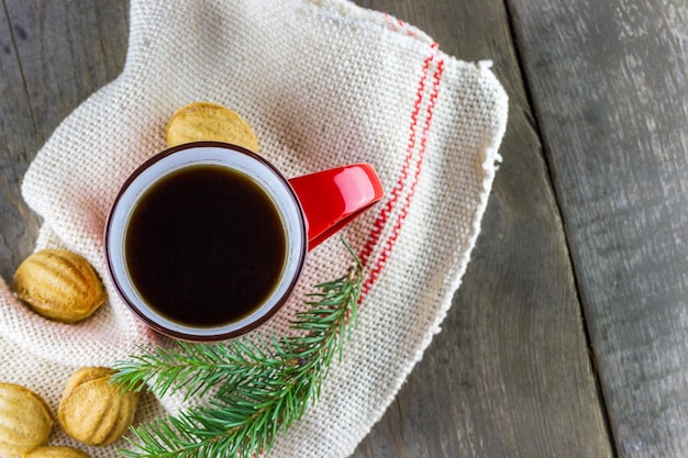 Cup of coffee with Christmas fir branch on the table