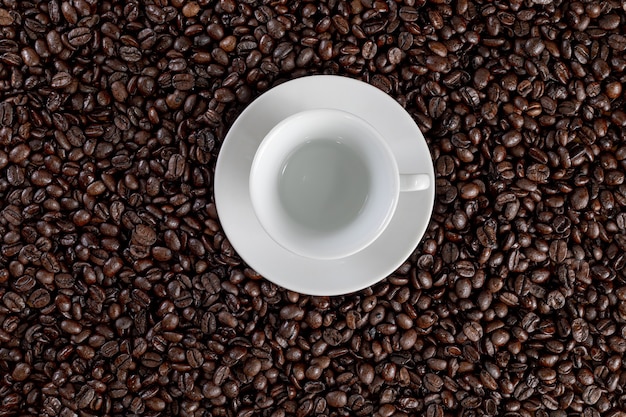 cup of coffee with coffee beans background