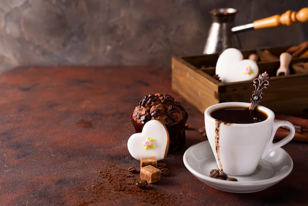 Cup of coffee with cooffee beans, wooden box with grains of coffee 