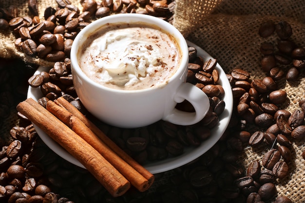 Cup of coffee with cream and cinnamon