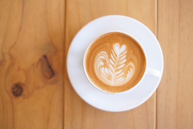 Cup of coffee with fern tree pattern milk foam