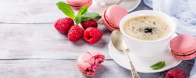 Cup of coffee with french raspberry macaroons