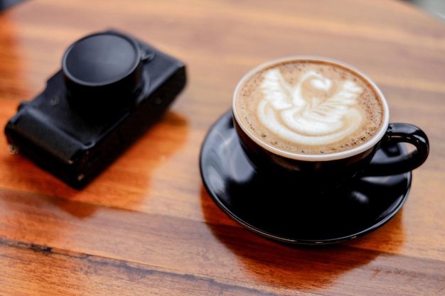 A cup of coffee with latte art on wooden table