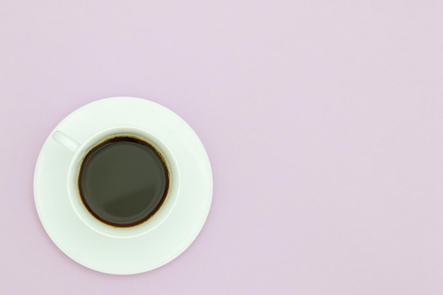 A cup of coffee with a purple background