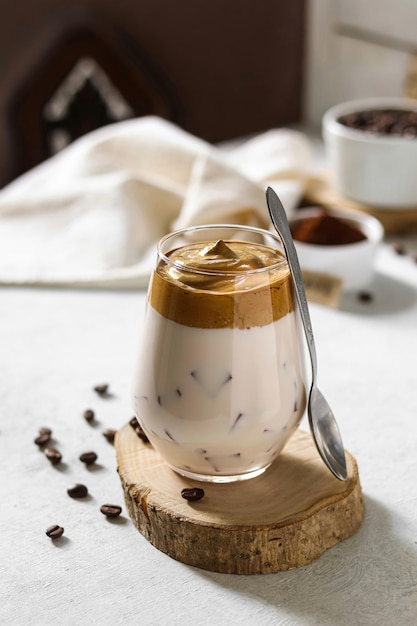 A cup of coffee with a spoon on a wooden table