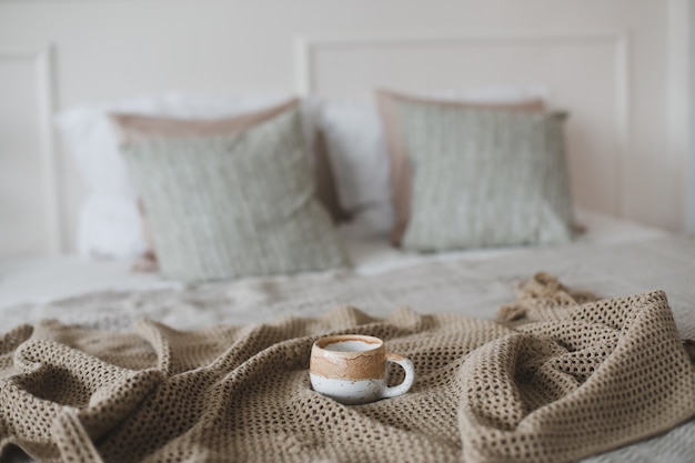 Cup of coffee with warm plaid Breakfast in bed