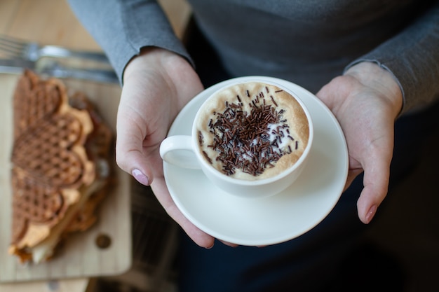 cup of coffee in woman's hands