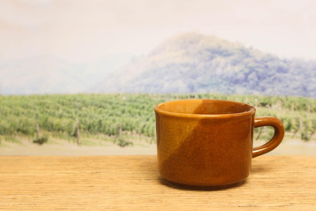 A cup of coffee on wood in the coffee plantation