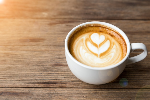 cup of coffee on wood table background