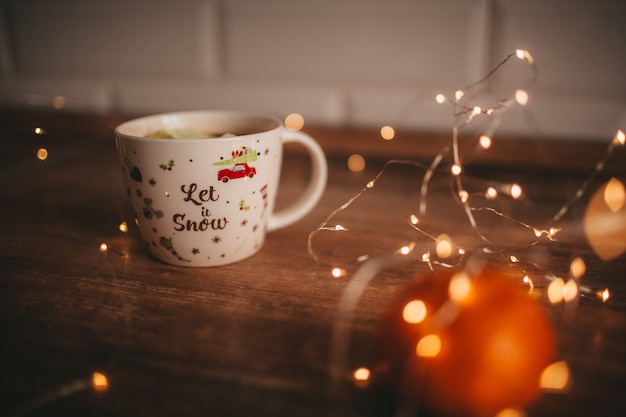 The cup of coffee on the wood table  with lights