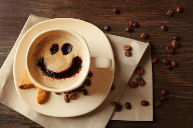 Cup of coffee on wooden table background