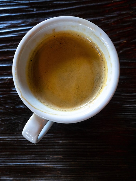 Cup of coffee on wooden table top view